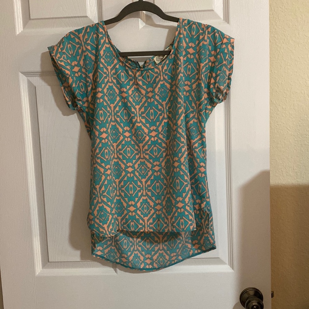teal and pink patterned blouse